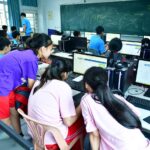adults in a training classroom using computers
