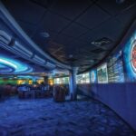 A cybersecurity analyst monitors multiple screens showing network data and security alerts.