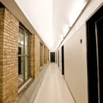 A data centre corridor lined with storage and server cabinets.