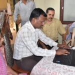 adults in a training classroom using computers