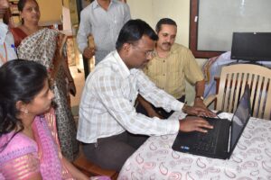 adults in a training classroom using computers