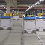 autonomous robots moving shelves in a warehouse