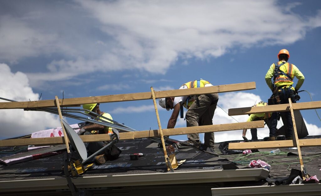 worker repairing an older house