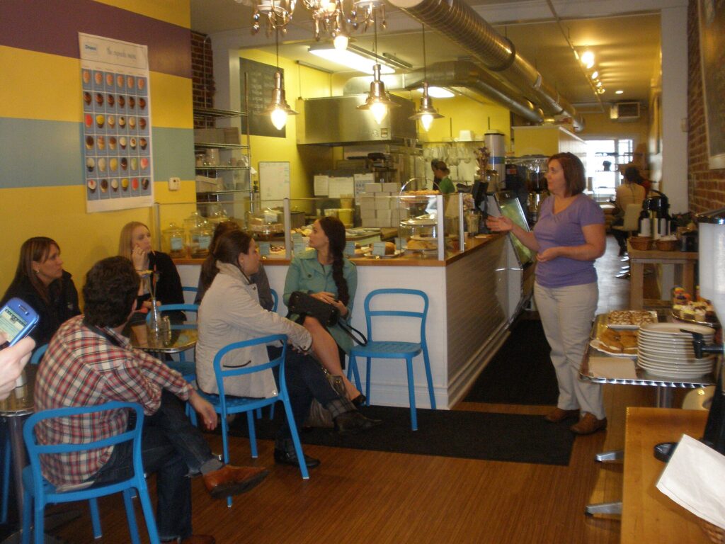The owner of a small independent shop serving a customer at the counter