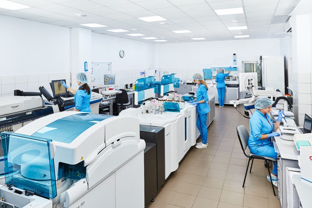 A female researcher in a white coat examining samples in a medical laboratory